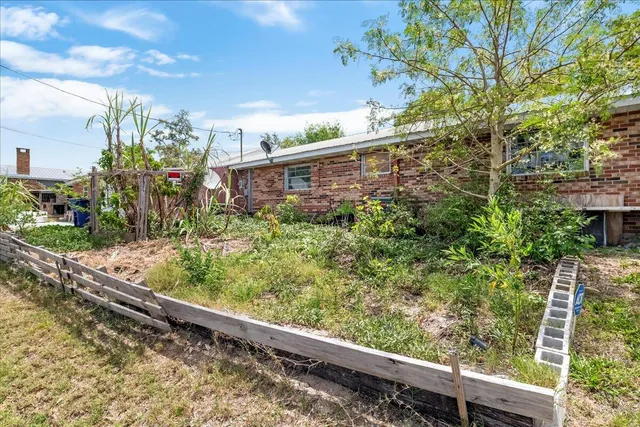 a view of a house with a flower garden
