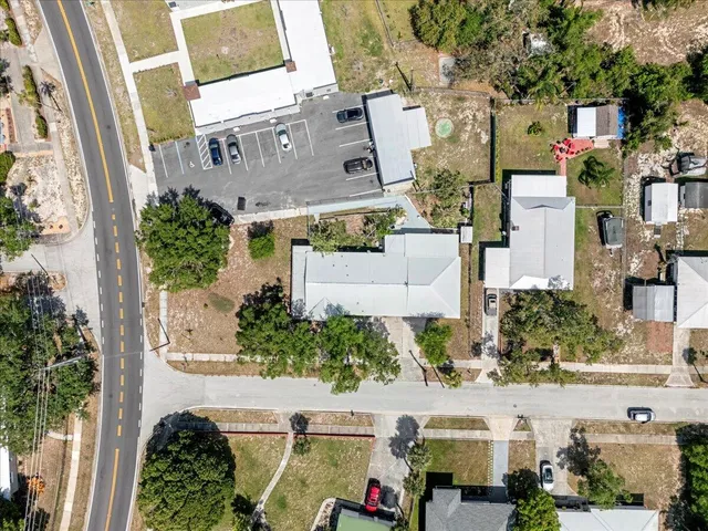 an aerial view of multiple houses with a yard