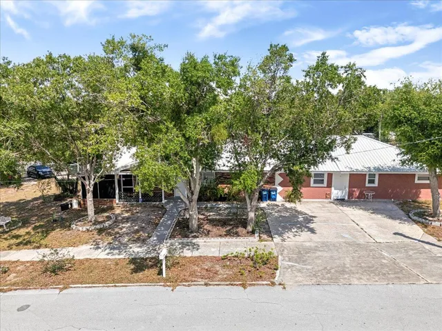 an aerial view of a house with a yard