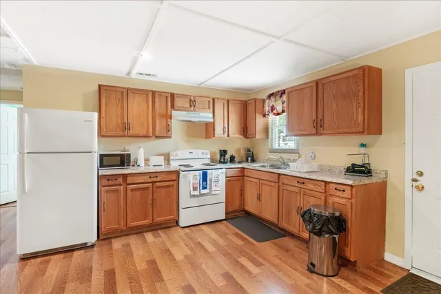 a kitchen with stainless steel appliances granite countertop a refrigerator sink and cabinets
