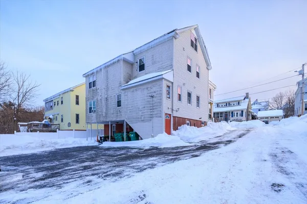 a view of a house with a snow in the yard