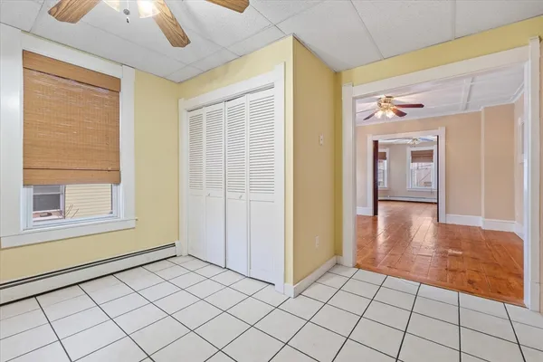 a view of empty room with wooden floor