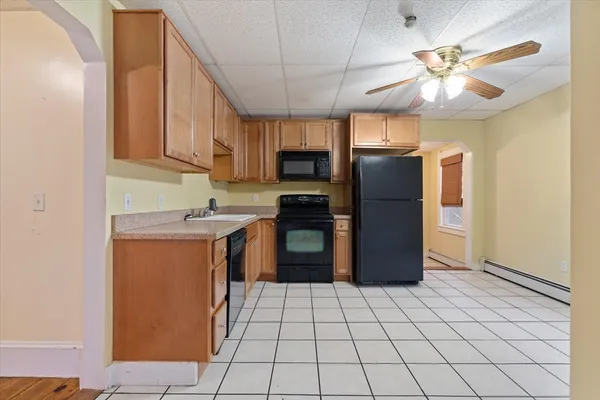a kitchen with stainless steel appliances granite countertop a refrigerator a stove and a sink
