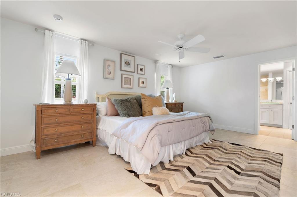 1980 Gordon Drive Naples, FL 34102 - Photo 11 of 14 a bedroom with a bed and a dresser