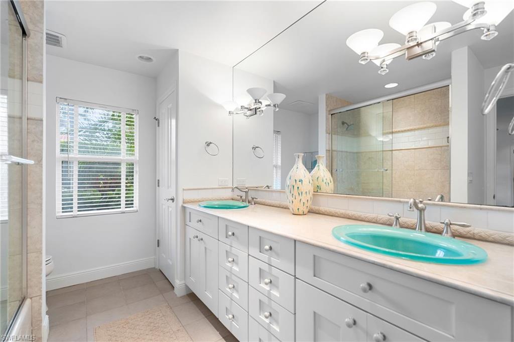 1980 Gordon Drive Naples, FL 34102 - Photo 12 of 14 a bathroom with a double vanity sink and a mirror