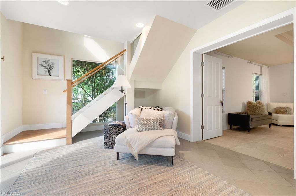 1980 Gordon Drive Naples, FL 34102 - Photo 8 of 14 a living room with furniture and a mirror