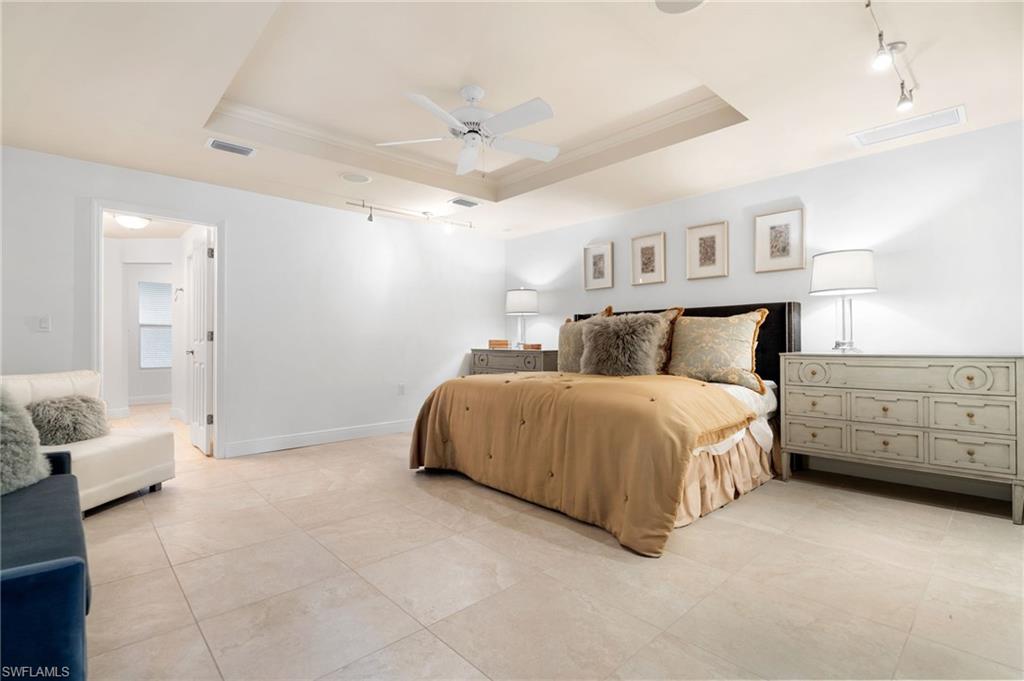 1980 Gordon Drive Naples, FL 34102 - Photo 9 of 14 a spacious bedroom with a bed and a window