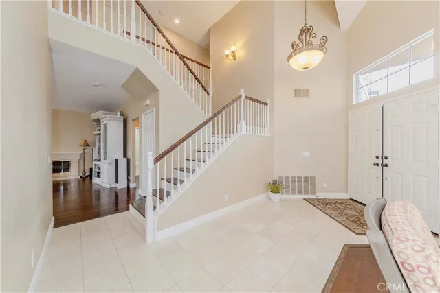 a large white kitchen with lots of counter top space and living room