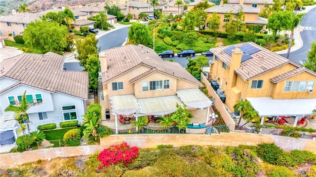 a living room with furniture a dining table and a chandelier