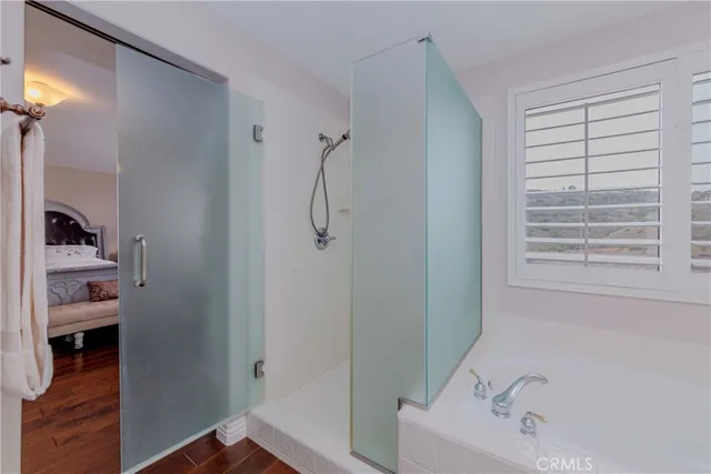 a bedroom with bed and a workspace