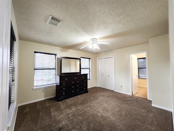 a room with window and dresser
