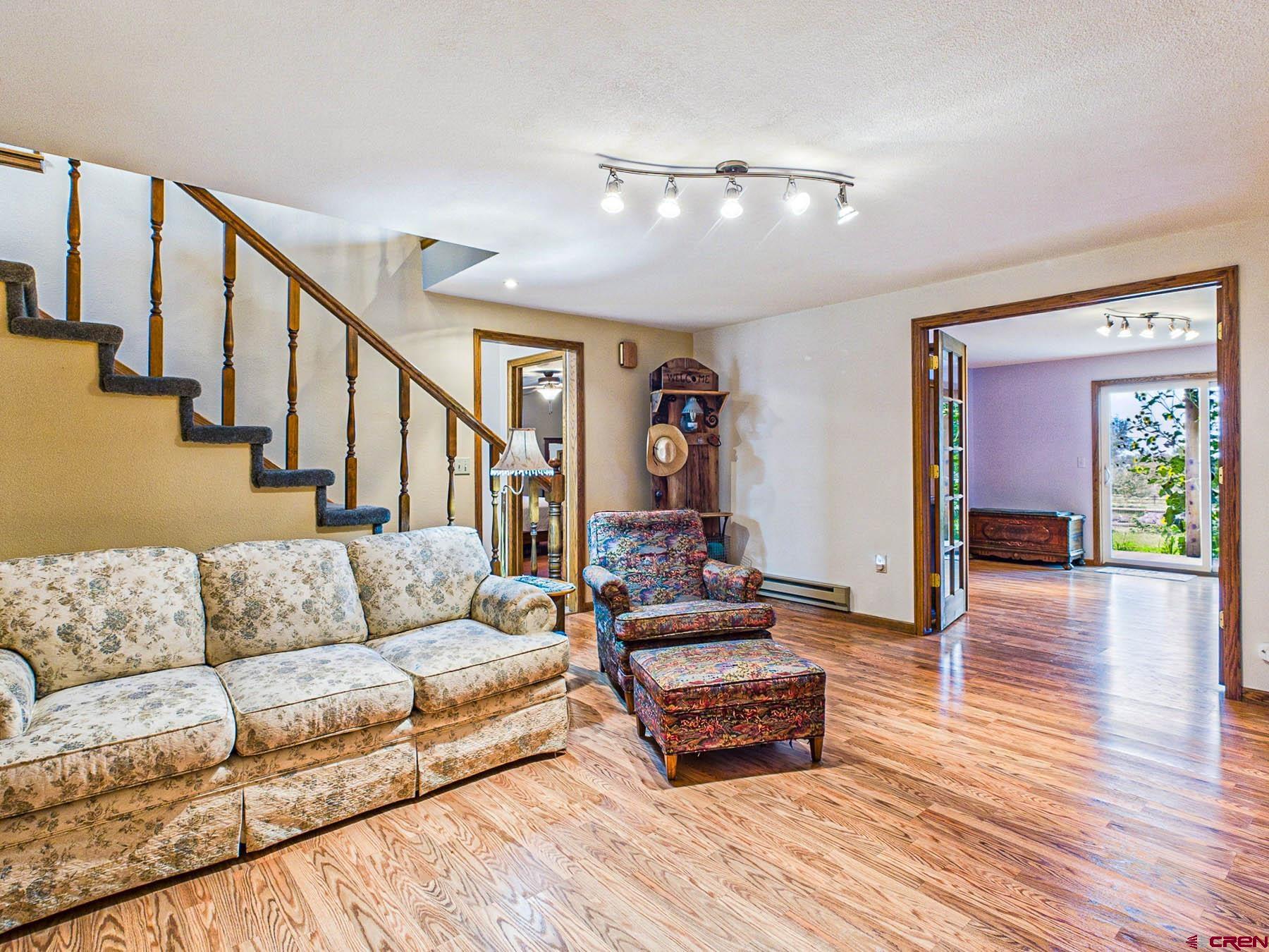 a living room with furniture and wooden floor