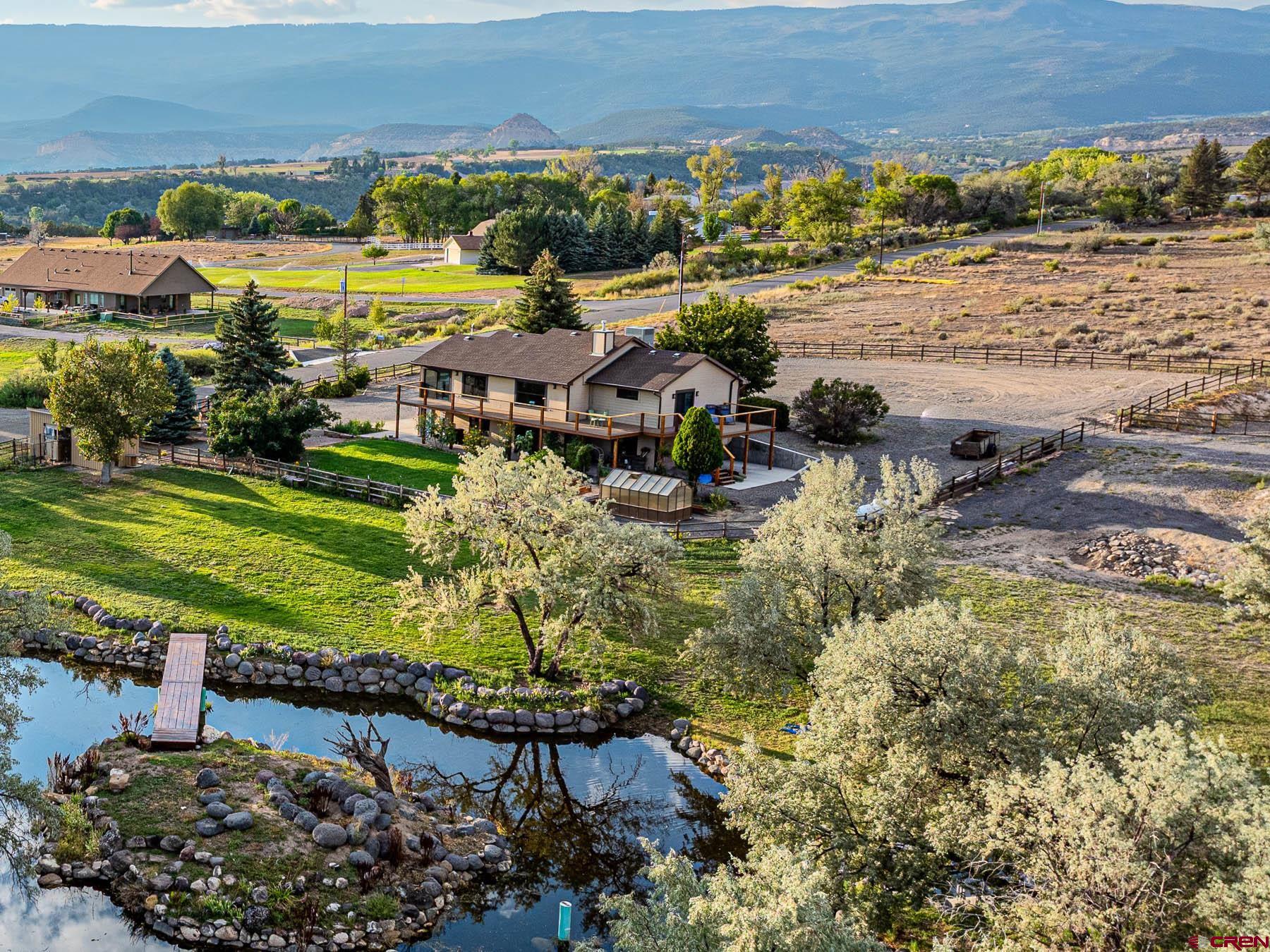 a view of a town with lawn chairs and large trees