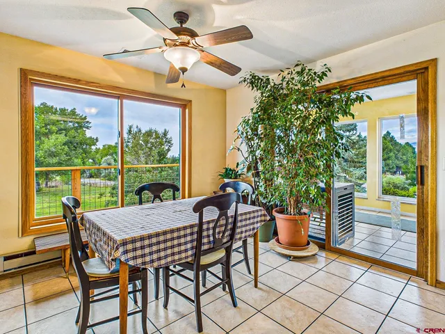 a view of a patio with a table chairs and a potted plant