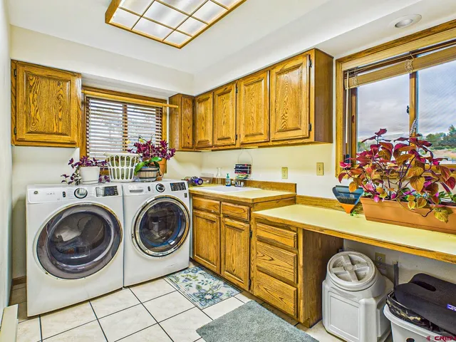 a utility room with sink dryer and washer