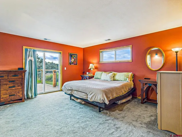 a bedroom with a bed and a lamp next to a window