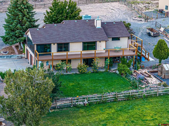 a aerial view of a house with a yard table and chairs