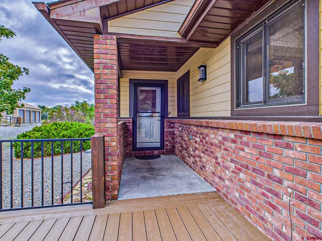 a view of backyard with a deck and wooden floor