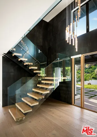 a view of a hallway with wooden floor and entryway
