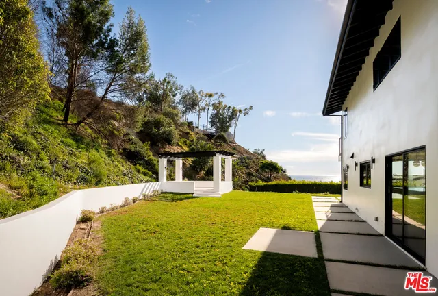 a view of an empty room with glass door and a window