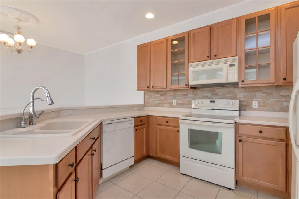125 Shell Falls Drive Apollo Beach, FL 33572 - Photo 14 of 48 a kitchen with stainless steel appliances granite countertop a sink stove and cabinets
