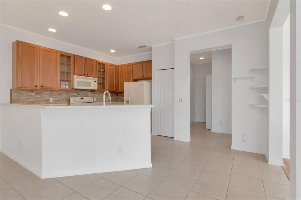 125 Shell Falls Drive Apollo Beach, FL 33572 - Photo 17 of 48 a kitchen with stainless steel appliances granite countertop a refrigerator and a stove top oven