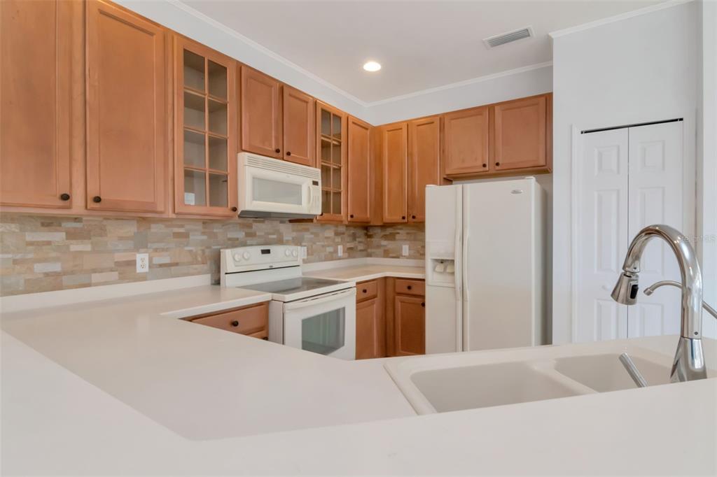 125 Shell Falls Drive Apollo Beach, FL 33572 - Photo 18 of 48 a kitchen with stainless steel appliances granite countertop a refrigerator sink and stove