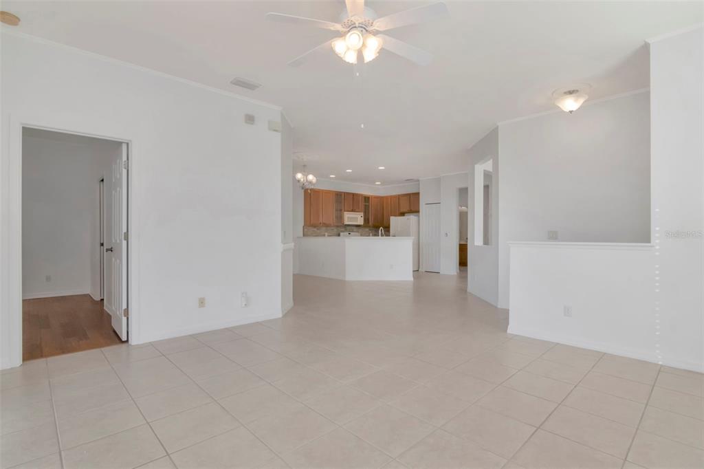 125 Shell Falls Drive Apollo Beach, FL 33572 - Photo 25 of 48 a view of a livingroom with a chandelier fan and kitchen view