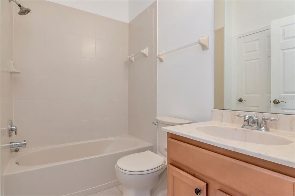 125 Shell Falls Drive Apollo Beach, FL 33572 - Photo 30 of 48 a bathroom with a sink a toilet and a bathtub
