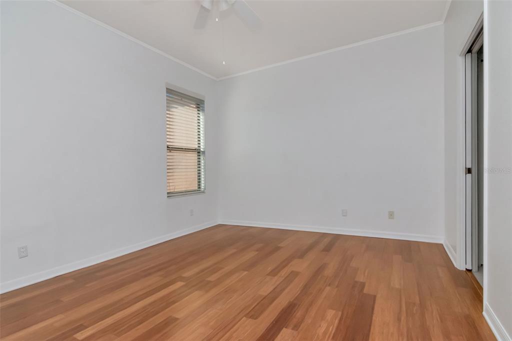 125 Shell Falls Drive Apollo Beach, FL 33572 - Photo 9 of 48 an empty room with wooden floor and windows