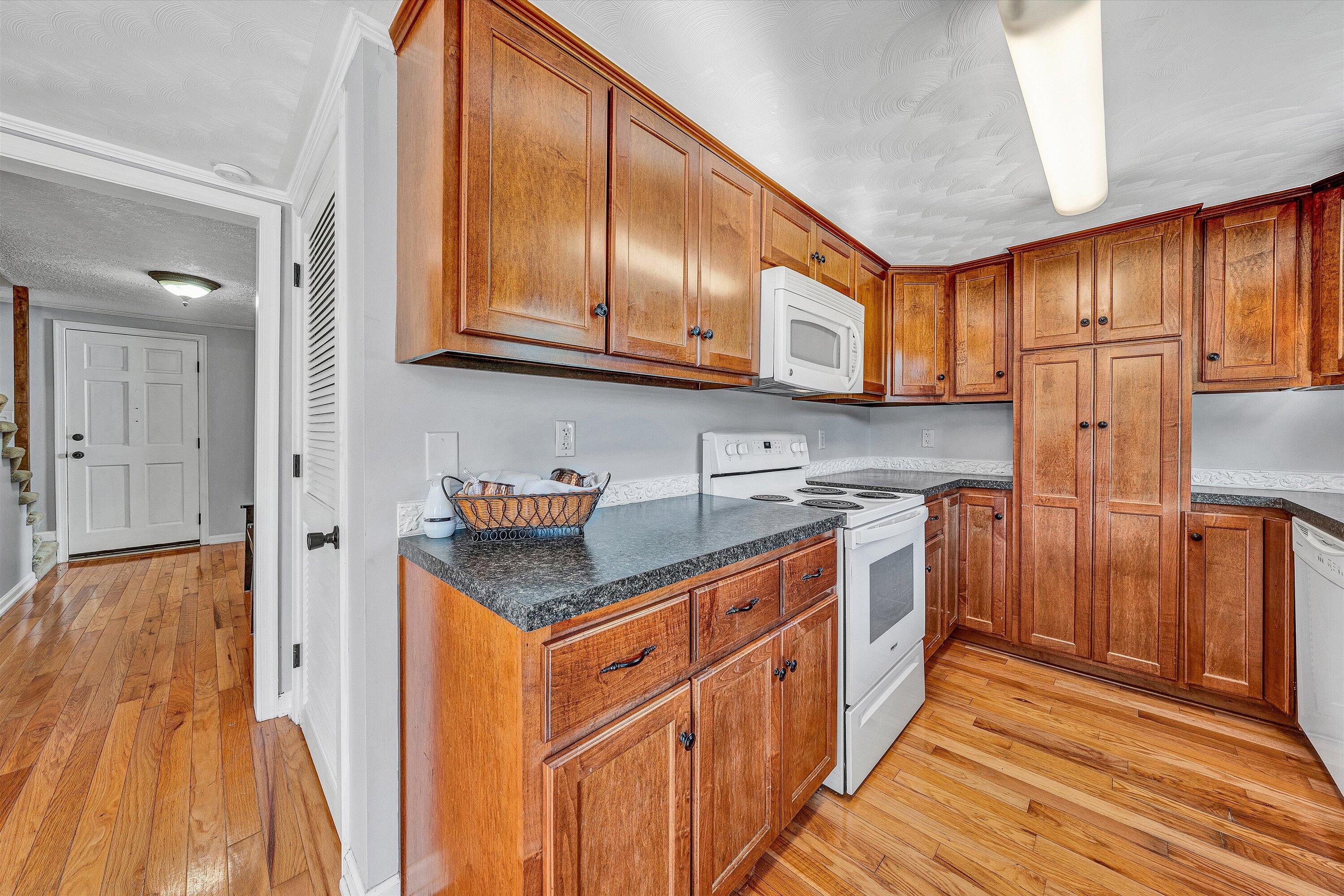 51 Mt Carmel Road Rocky Mount, VA 24151 - Photo 15 of 37 a kitchen with stainless steel appliances granite countertop a refrigerator a sink dishwasher and wooden cabinets with wooden floor