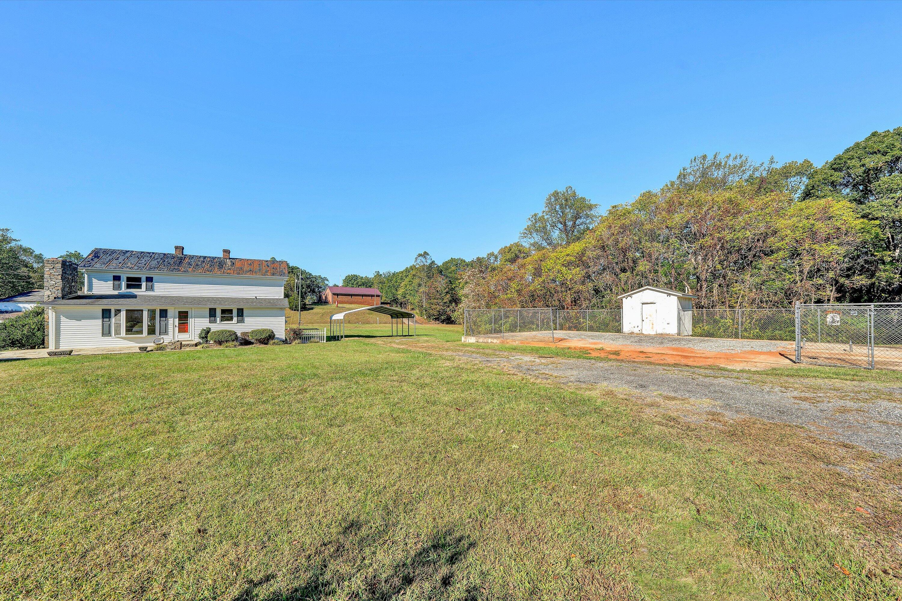 51 Mt Carmel Road Rocky Mount, VA 24151 - Photo 36 of 37 a view of a big house with a big yard and large trees