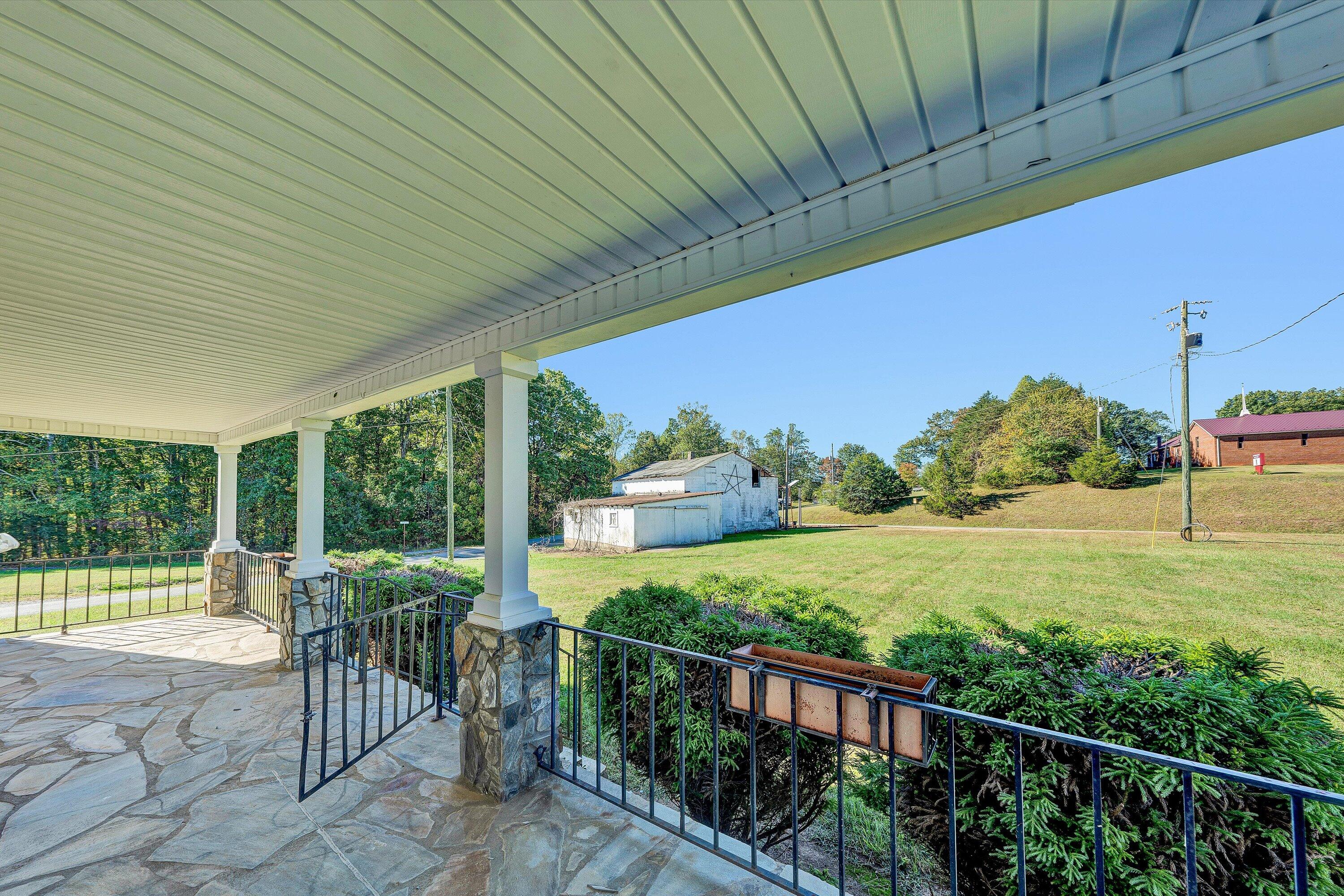 51 Mt Carmel Road Rocky Mount, VA 24151 - Photo 5 of 37 a view of a patio with lawn chairs next to a yard