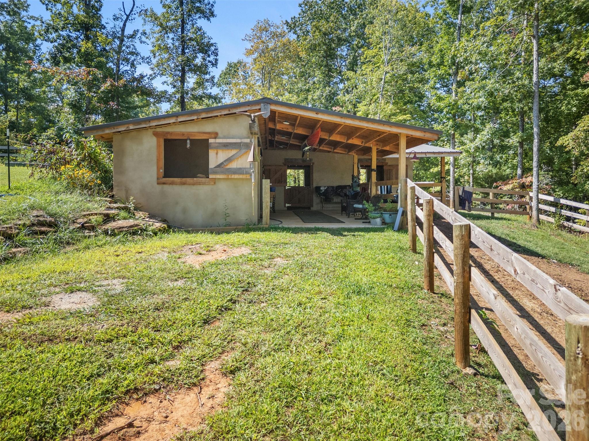 250 Burt Blackwell Road Mill Spring, NC 28756 - Photo 22 of 47 a view of a house with backyard and sitting area