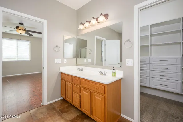 a bathroom with a sink vanity and mirror