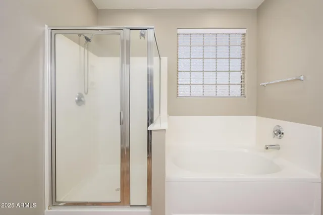 a bathroom with a bathtub and a shower