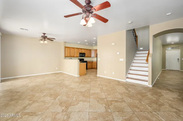 a view of a kitchen with a sink and a ceiling fan