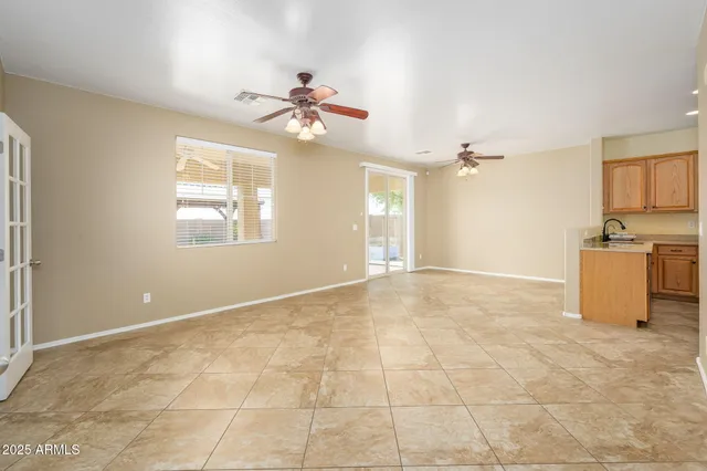 a view of a kitchen with wooden cabinet and a chandelier fan