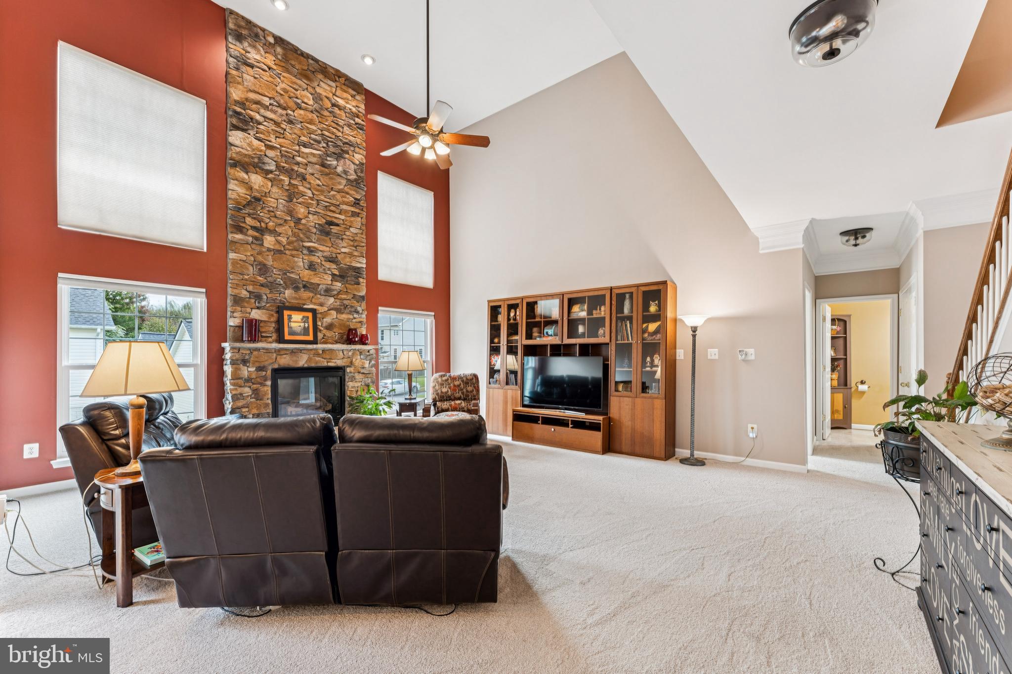 18423 Thundercloud Road Boyds, MD 20841 - Photo 12 of 58 a living room with furniture a fireplace and a chandelier