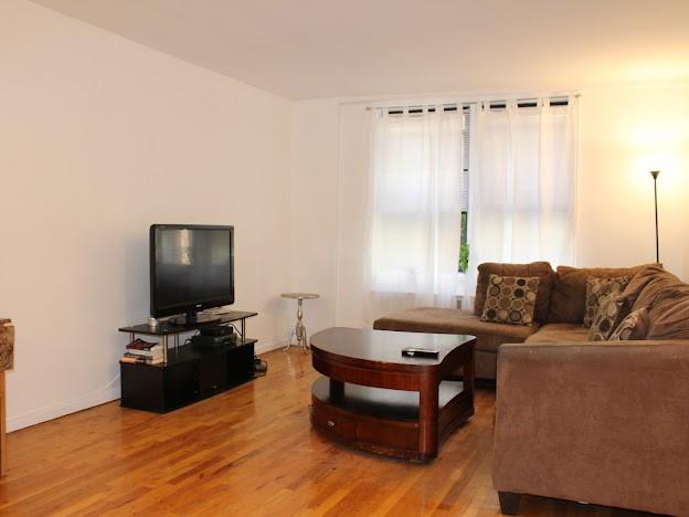 275 Webster Avenue, Unit 3A Brooklyn, NY 11230 - Photo 4 of 20 a living room with furniture and a flat screen tv