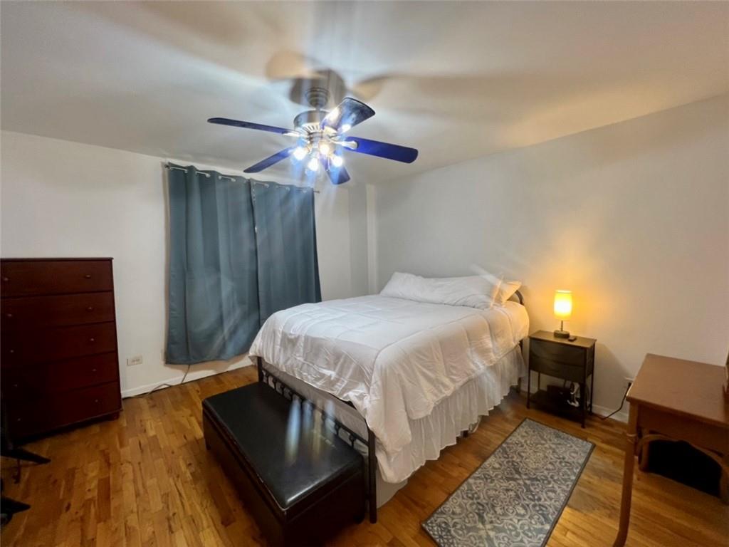275 Webster Avenue, Unit 3A Brooklyn, NY 11230 - Photo 9 of 20 a bedroom with a bed lamp and a chandelier