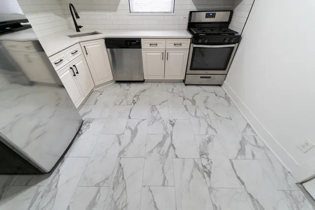 a utility room with sink dryer and washer