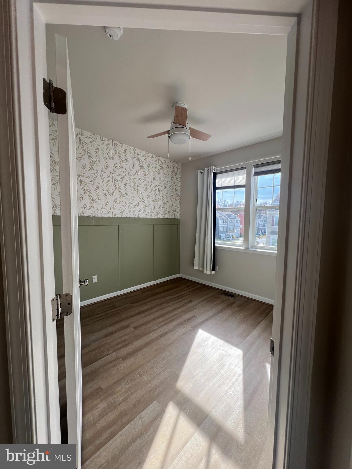 3106 Laurel Hill Road Hanover, MD 21076 - Photo 15 of 25 a view of empty room with wooden floor and fan