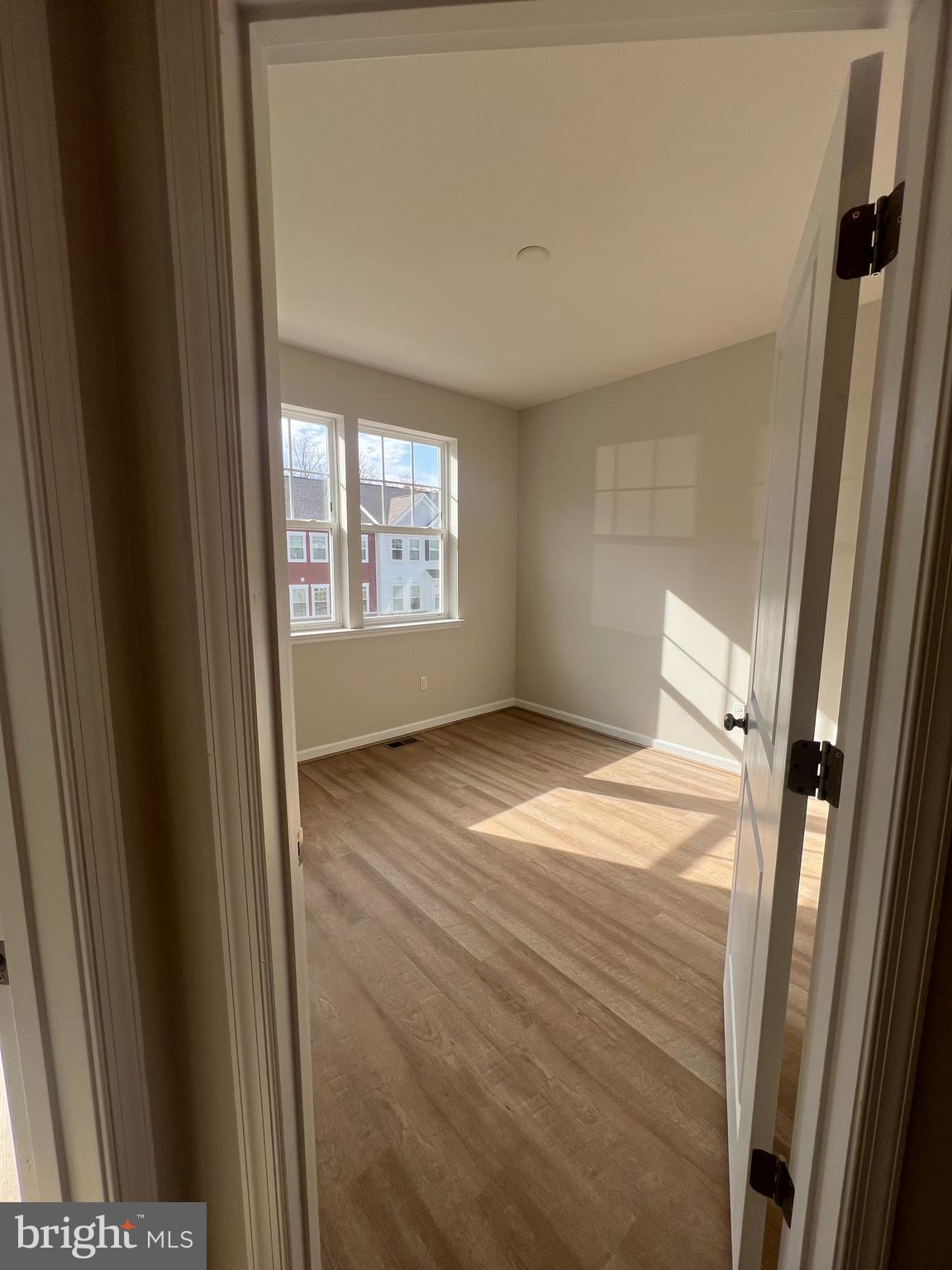 3106 Laurel Hill Road Hanover, MD 21076 - Photo 16 of 25 a view of empty room with wooden floor and fan