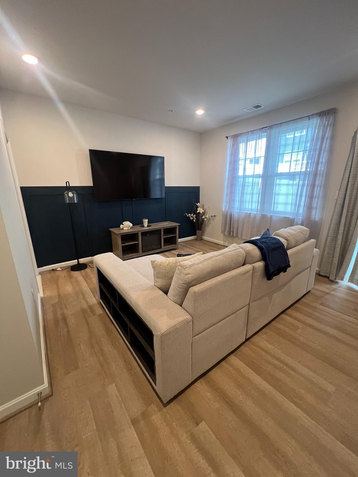 3106 Laurel Hill Road Hanover, MD 21076 - Photo 19 of 25 a living room with furniture and a flat screen tv
