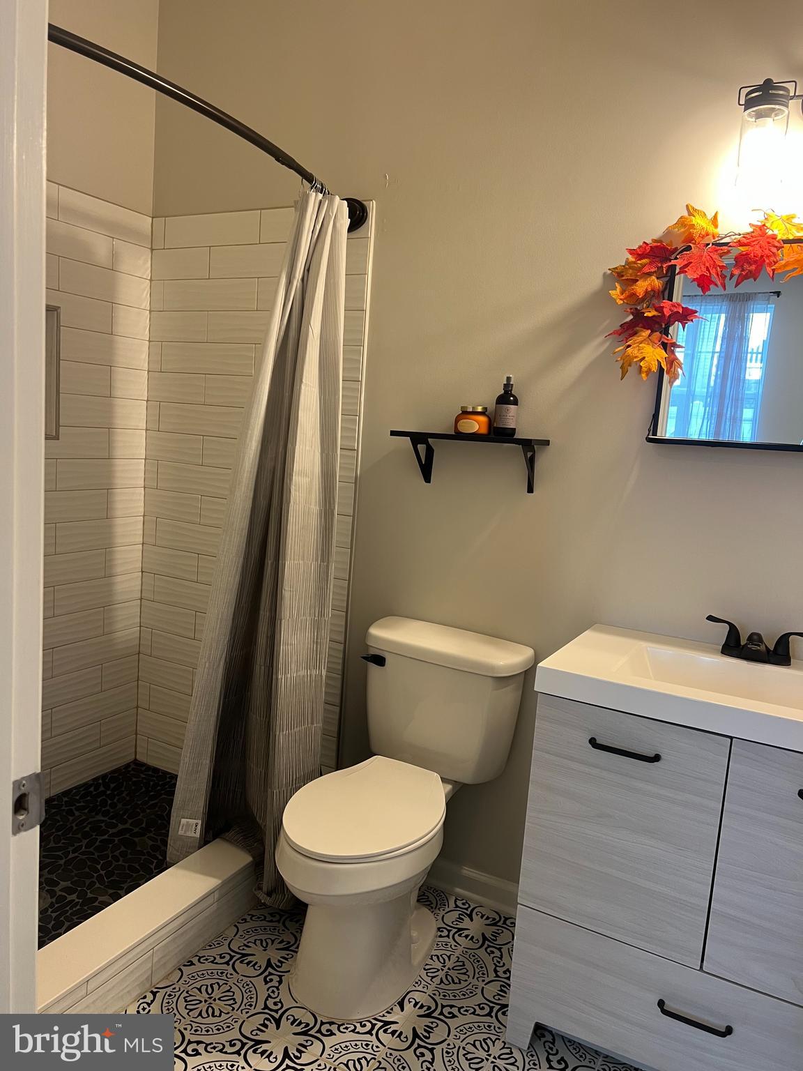 3106 Laurel Hill Road Hanover, MD 21076 - Photo 22 of 25 a bathroom with a toilet and a shower curtain
