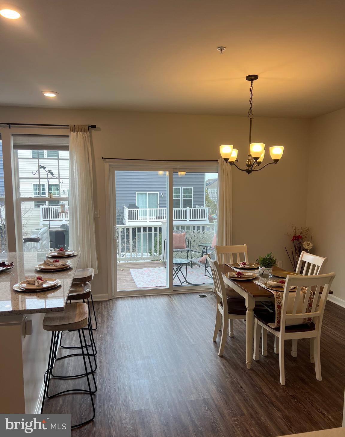 3106 Laurel Hill Road Hanover, MD 21076 - Photo 8 of 25 a dining room with furniture a chandelier and wooden floor