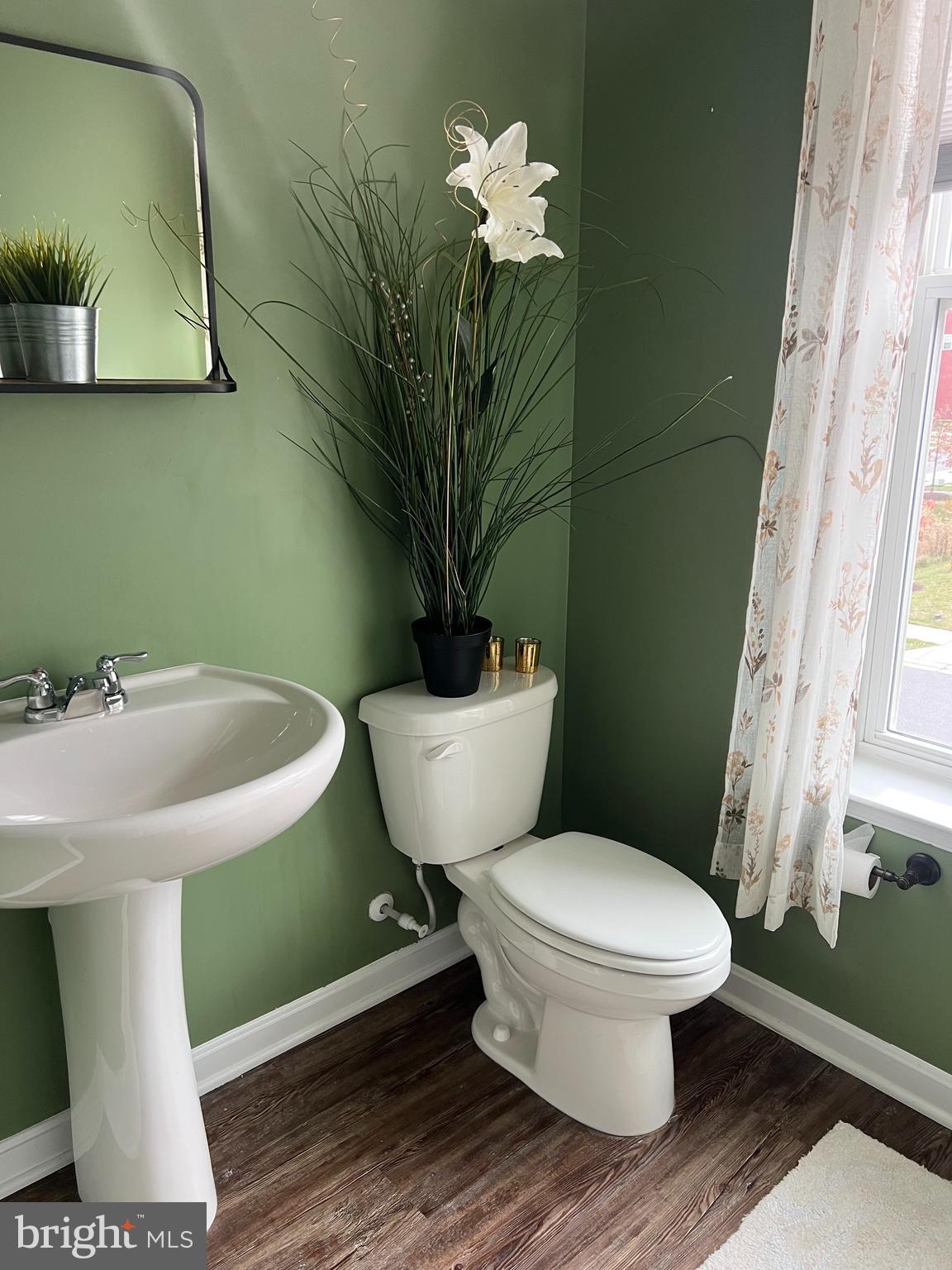 3106 Laurel Hill Road Hanover, MD 21076 - Photo 9 of 25 a bathroom with a toilet sink and mirror