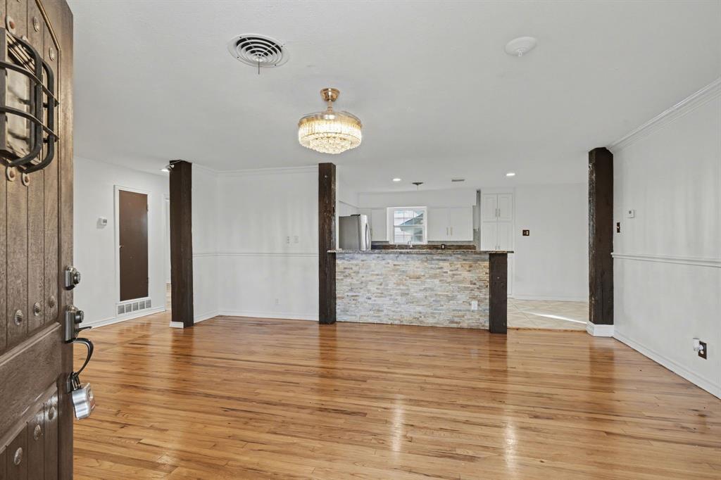1714 East Union Bower Road Irving, TX 75061 - Photo 6 of 32 an empty room with wooden floor and entrance