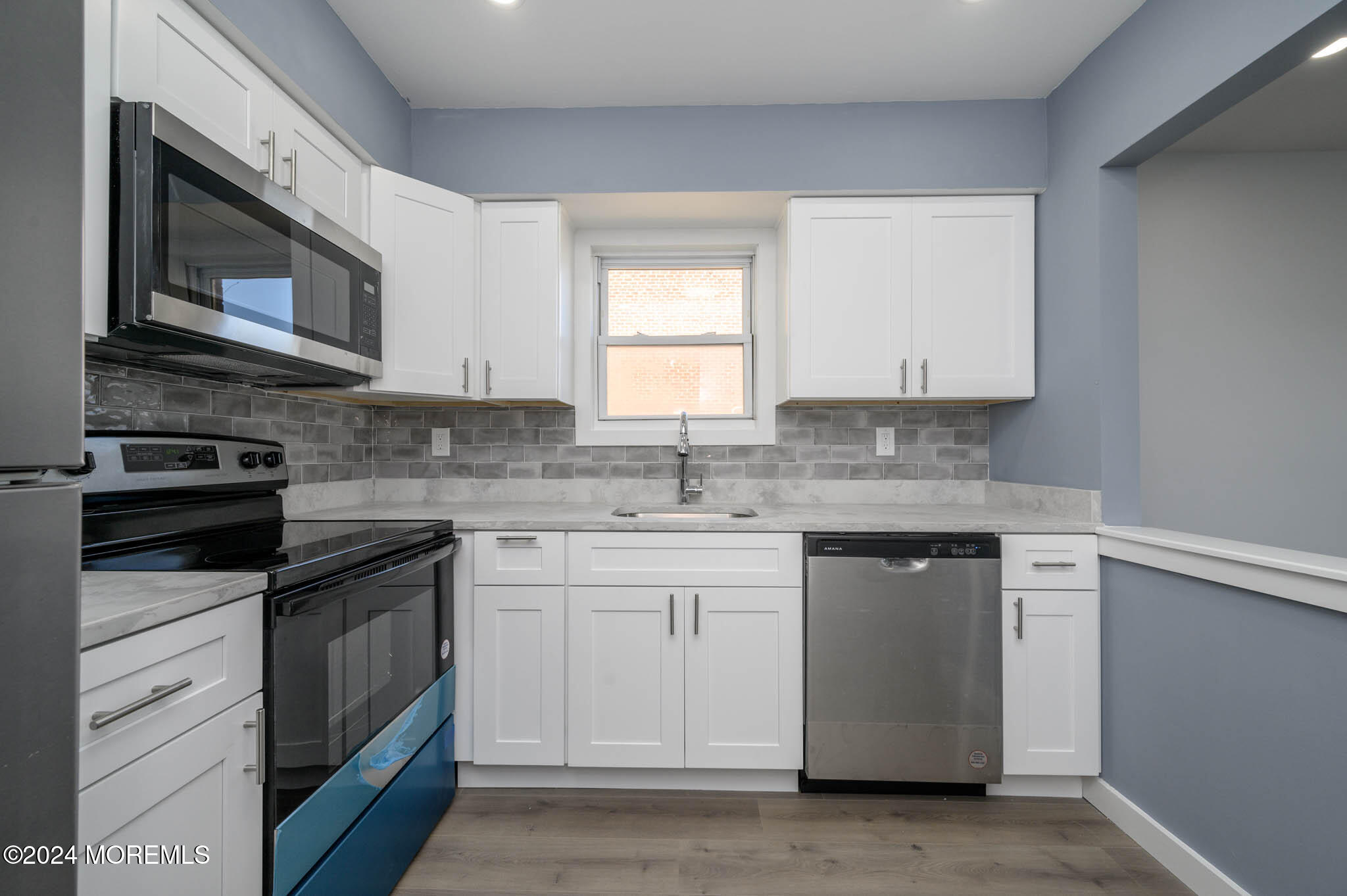 246 Sawmill Road, Unit 403 Brick, NJ 08724 - Photo 11 of 41 a kitchen with granite countertop white cabinets stainless steel appliances and a sink